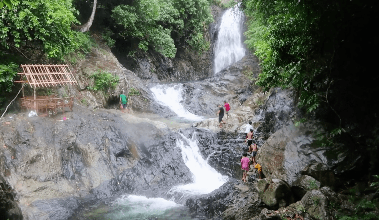 local filipino kids going closer to the Hicming waterfall in catanduanes province philippines
